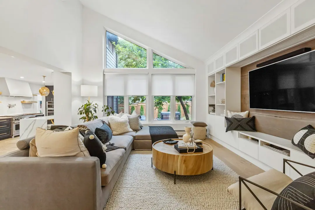 A bright living room with a grey sofa and a switched-off wall TV, where Nexus4kTV can be tested